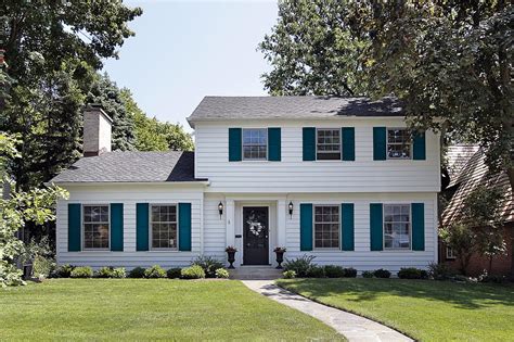 white house with white metal roofing green shutters|wood shutters on white house.